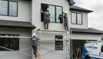 Technician performing window repair on Memphis TN home exterior with vinyl siding